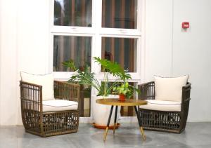 a porch with chairs and a table and a window at Bambu Suites in Puerto Princesa City
