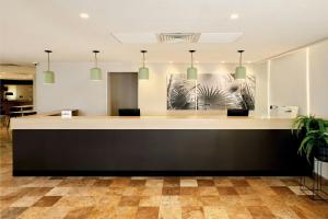 an office reception counter with pendant lights at City Express by Marriott Cancun in Cancún +70 photos