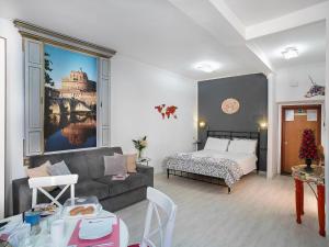 a living room with a couch and a bed at Navona Open Space Apartments in Rome
