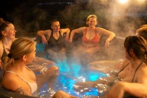a group of people in a hot tub at Willa Marianna in Lądek-Zdrój