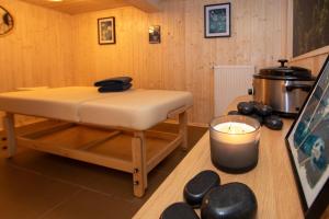 a room with a bench and a candle on a table at Willa Marianna in Lądek-Zdrój