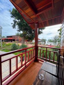a porch with a wooden table and a view at Lamphu Resort Koh Lanta at Lanta Old Town in Ko Lanta