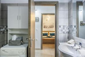 a bathroom with a sink and a toilet at Dimitra's House in Glossa