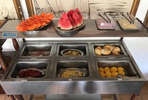 a buffet with different types of fruits and vegetables at Pousada Colonial Penedo - Alagoas in Penedo