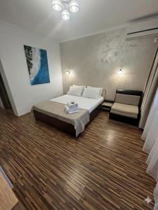 a hotel room with a bed and a chair at Casa Asteria - Mamaia Nord in Mamaia Sat/Năvodari