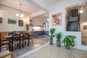 a dining room and kitchen with a table and chairs at SunWave Residence in Agios Nikolaos