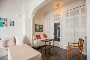 a bedroom with a bed and a table and a couch at SunWave Residence in Agios Nikolaos