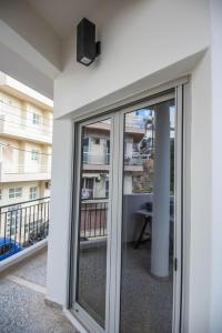 a balcony with sliding glass doors in a building at SunWave Residence in Agios Nikolaos