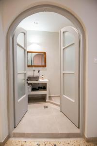 an archway leading into a bathroom with a sink at SunWave Residence in Agios Nikolaos +35 photos