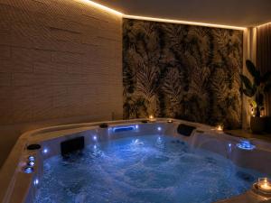 a jacuzzi tub with blue water in a room at GG Landlords Room & Spa in Vasto