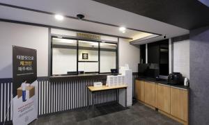 an office with a counter and a desk and a window at Gukmin Hotel in Gumi