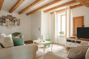 a living room with a couch and a table at Opaline à la Rochelle in Vergné