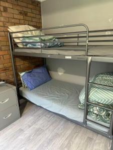 a couple of bunk beds in a room at Tranquil Waters Edge Escape in Sanctuary Point