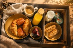 a tray with two plates of pastries and a cup of coffee at Osé in Chênet