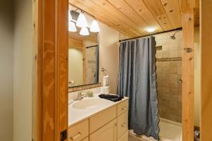 a bathroom with a sink and a shower at Velvet Timber Haus | HotTub, Sauna, Firepit, Games in Windham +46 photos