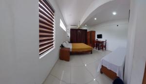 a bedroom with a bed and a table in a room at Devi Royal Residency in Mararikulam