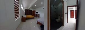 a hallway leading to a bedroom and a bathroom at Devi Royal Residency in Mararikulam
