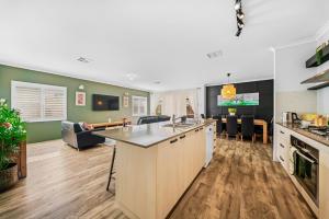 an open kitchen and living room with a couch at Garrison Cottage in The Vines