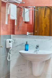 a bathroom with a sink and a mirror and towels at Vila Etikette in Baile Felix +29 photos