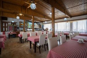 a restaurant with red and white tables and chairs at Zeynep Hanim Konagi in Gaziantep