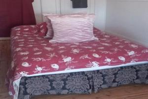 a bed with a pink blanket and a pillow at The Ashford Hotel and Restaurant in Ashford