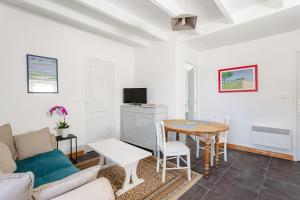 a living room with a couch and a table at Gite Les Jardins d'Harmonie in Bourgneuf