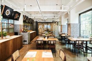 a restaurant with tables and chairs in a room at La Casa Hotel Seoul in Seoul