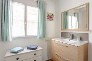 a bathroom with a sink and a mirror and a window at Gite Les Jardins d'Harmonie in Bourgneuf +14 photos