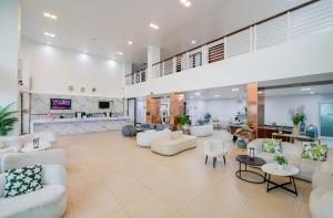 a lobby with white couches and tables at The Kris Resort Hotel in Patong Beach