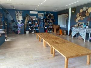 a large wooden table in a room with blue walls at 民宿あわい in Nakijin +8 photos