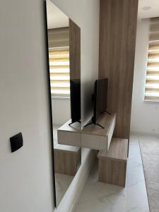 a living room with a tv and a mirror at Miri Apartments in Ulcinj