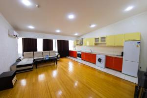 a room with a kitchen and a living room at Avenue Hotel Tashkent in Tashkent