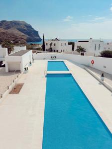 a pool on the side of a building with blue water at Las Negras Olivencia Natural in Las Negras