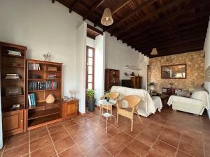 a living room with a couch and a table at Private villa with pool in the mountains in Pájara