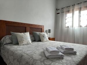 a bedroom with a bed with two towels on it at Private villa with pool in the mountains in Pájara +20 photos
