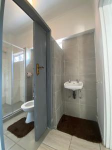 a bathroom with a toilet and a sink at Fiet Star in Midrand +11 photos