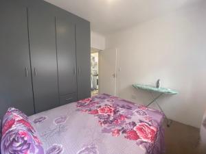 a bedroom with a bed with a floral bedspread at Fiet Star in Midrand
