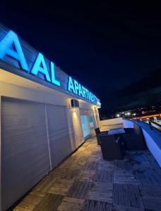 a building with a sign on top of it at night at Reaal Apartaments 1 in Mazgit