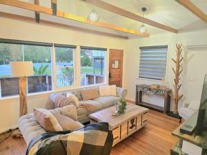 a living room with a couch and a table at Beach House in Surf Beach