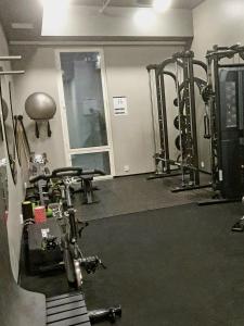 a gym with several treadmills and machines in it at Downtown studio, near railwaystation, with exercise facilities in Seinäjoki