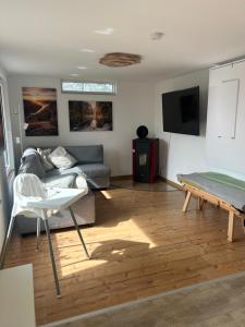 a living room with a couch and a table at Ferienhaus Abendsonne in Sebnitz - Sächsische Schweiz in Sebnitz