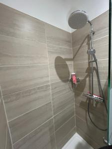 a shower with a glass door in a bathroom at Chez Rémi in Écommoy +3 photos