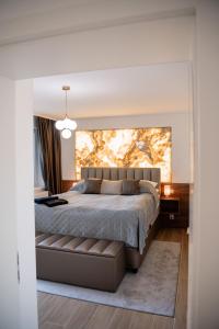 a bedroom with a large bed with a large painting on the wall at ADELA VIP Nezábudka - Tiché krídlo, 45m2 a TOP spánok in Tatranska Strba