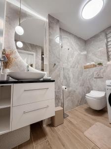 a bathroom with a sink and a toilet at ADELA VIP Nezábudka - Tiché krídlo, 45m2 a TOP spánok in Tatranska Strba