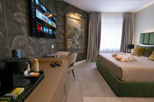 a hotel room with a bed and a desk at Giorgio Raggi Hospitality in Terni