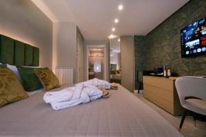 a bedroom with a bed with a pile of towels on it at Giorgio Raggi Hospitality in Terni