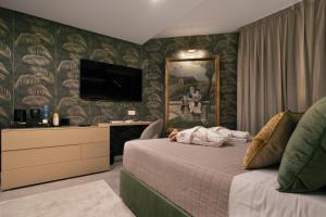 a bedroom with a bed and a painting on the wall at Giorgio Raggi Hospitality in Terni +34 photos
