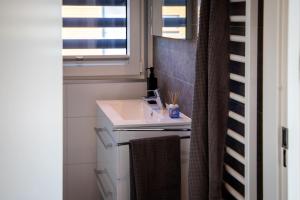 a bathroom with a sink and a window at Floatinghouse Grasshopper in Klitten
