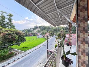 a balcony with a view of a street at Toba Boi in Tuktuk Siadong +11 photos