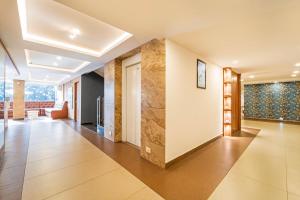 a hallway of a house with a living room at Treebo Medco Mansion in Kozhikode